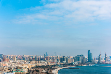 Fototapeta premium Bright panoramic cityscape view of Baku, Azerbaijan. The downtown scenic view to old city and modern with tall skyscrapers near the coast of Caspian sea.