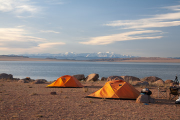 Cloudy view on a mountain lake. Mongolia tent on beach