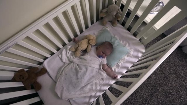 Cute Baby Sleeps In Crib With Pacifier As Bird Mobile Is Revealed Overhead
