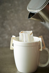 Hand drip coffee in white mug cup 