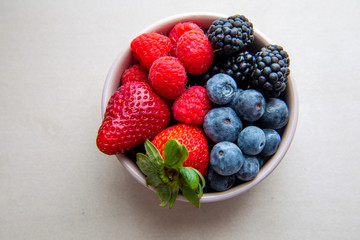 strawberries, blueberries, blackberries and raspberries in the bowl