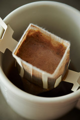 Hand drip coffee in white mug cup 