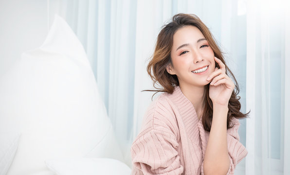 Portrait of young beautiful asian woman relax face in winter bedroom. Sexy beauty girl with healthy makeup facial treatment perfect glow skin. Smile happy asian korean girl isolated white background.