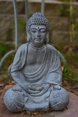 Close up of a gray stone Budda statue