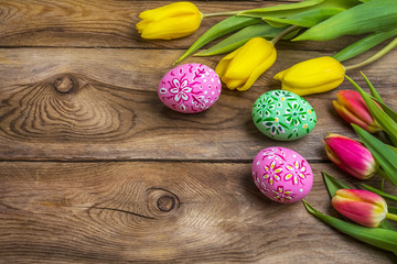 Easter greeting with eggs and yellow red tulips