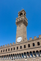 Fototapeta na wymiar Clock Tower and Embattlements on Palazzo Vecchio in Florence