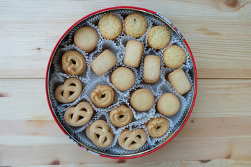 Many butter cookies in a round red box