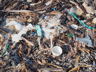 Environmental pollution. Sand beaches polluted with pieces of plastic waste. Micro plastics debris...