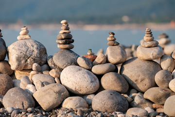 the wall of stones collected in a pyramid on the beach pebbles are not large