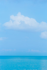 Floating clouds, fluffy colors against the blue sky and the sea