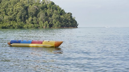 Image of seascape with hill and banana boat