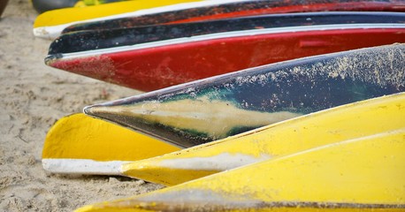 Beautiful view of colorful kayak or canoes at a beach