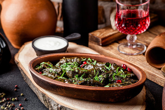 Traditional Georgian and Armenian cuisine. The dish "Dolma" or "Tolma". Cabbage rolls of grape leaves with rice and minced meat. Copy space, background image