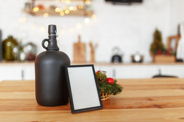 The frame on the wooden table and the blurry interior of the kitchen in the background. Design preparation