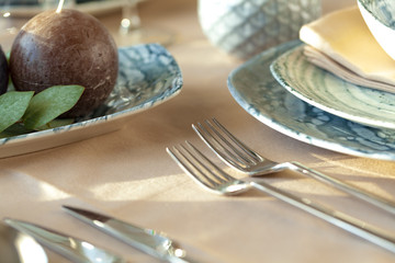 Silver cutlery on table top with tablecloth