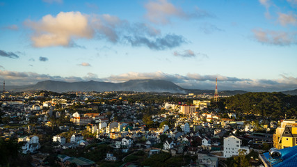 Fototapeta na wymiar Cityscape of Dalat, Vietnam.Beautiful landscape view for mountains and buildings.Beautiful tiny houses.Da lat city in the blue sky background