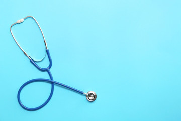 Stethoscope on color background. Cardiology concept