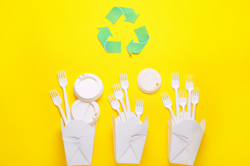 Plastic dinnerware on color background. Recycling concept