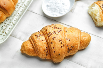 Tasty croissant on white table