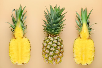 Fresh ripe pineapples on color background