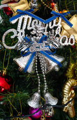 silver merry chirstmas word and Ornaments on christmas tree