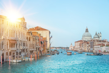 Naklejka premium Sun flash and old cathedral of Santa Maria della Salute. The colorful venice view for historic architecture background. Venice, italy, europe.