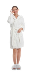 Young woman in bathrobe on white background