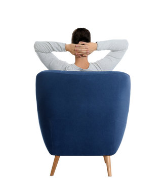 Young Man Sitting In Armchair On White Background, View From Back