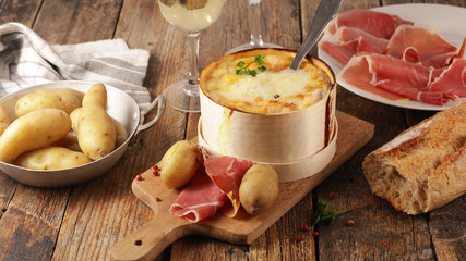 fondue cheese, french gastronomy with salami and potato