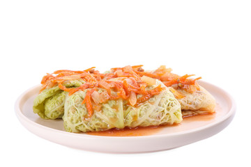 Plate with delicious cabbage rolls isolated on white