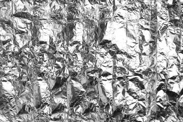 Crumpled silver foil as background, closeup view