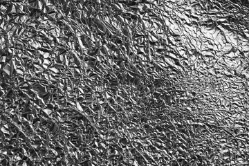 Crumpled silver foil as background, closeup view