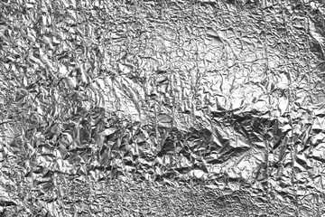 Crumpled silver foil as background, closeup view