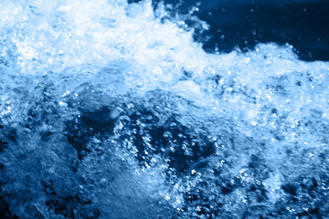 Fototapeta na wymiar Classic blue 2020. Gradient color palette. Splashing waves on the water. Blue water background.