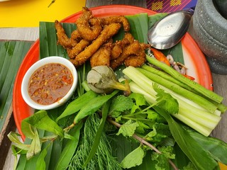Deep-fried pork dipped in chili paste and fresh vegetables, local food of Thailand
