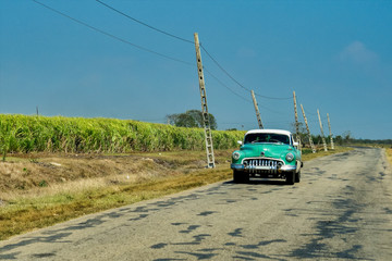 Classic american car on the road to Cienfuego in Cuba