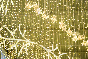 Festive decoration of shops, shopping centers. Electric garland, christmas lights