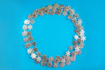 Garland wreath close-up. Wreath of snowflakes on a blue background and copy space.