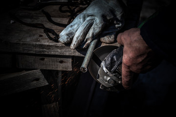 An experienced welder at work. Preparation and welding process of cast iron furnace. Selection focus. Shallow depth of field. Toned