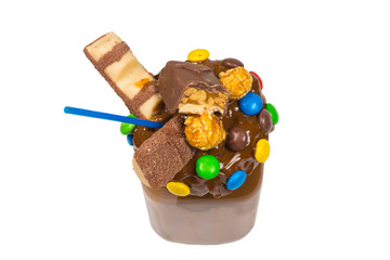 Chocolate milkshake with whipped cream, cookies, waffles, served in glass mason jar. 