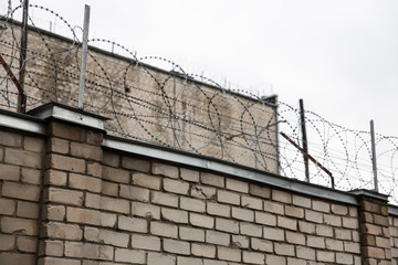 Prison or protected area. High brick walls with barbed wire.