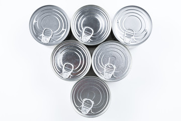 Group of silver canned food on white background.