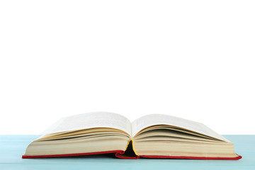 Open old hardcover book on wooden table