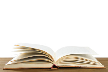 Open old hardcover book on wooden table