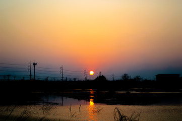 sunset with lagoon and electric pole