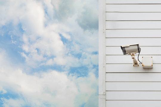 Closed-circuit Television On White Wood House Lid With Blue Sky And Cloud