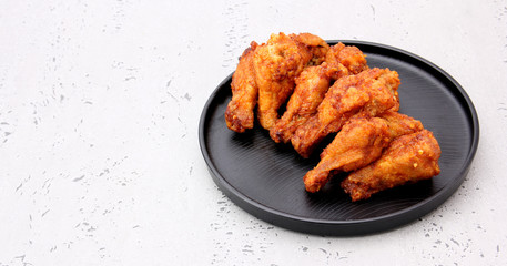Korean fried chicken wings isolated on a gray background in studio.