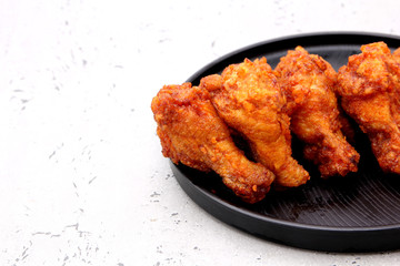 Korean fried chicken wings isolated on a gray background in studio.