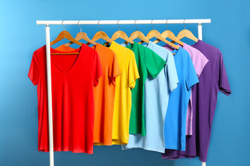 Bright clothes on blue background. Rainbow colors