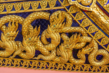 Thai art, carvings using gold color on the decorative plants on the royal ceremonies boat.